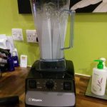 Vitamix blender on counter blending almond milk.