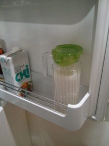 View of a jug of almond milk stored in a frdge.