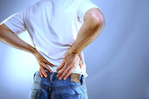 Man holding his lower back due to back pain